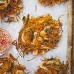 Ukoy shrimp and vegetable fritters on a baking tray with parchment paper.