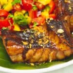 Tuna Belly with Tomato Mango Salsa on a plate with banana leaf.