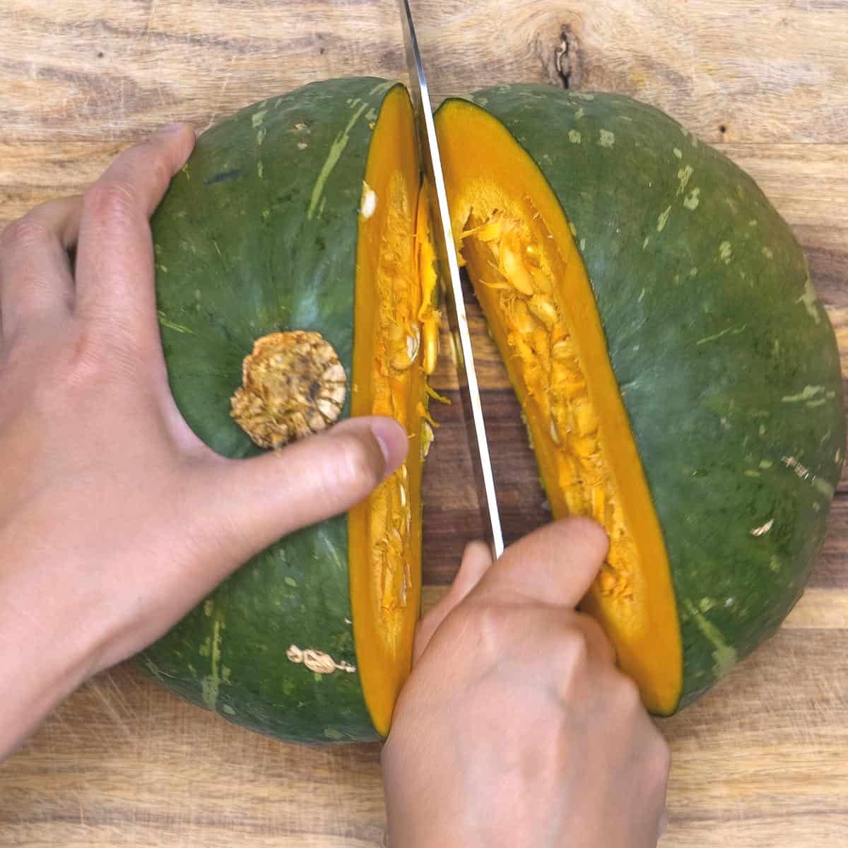 Cutting kabocha squash in half