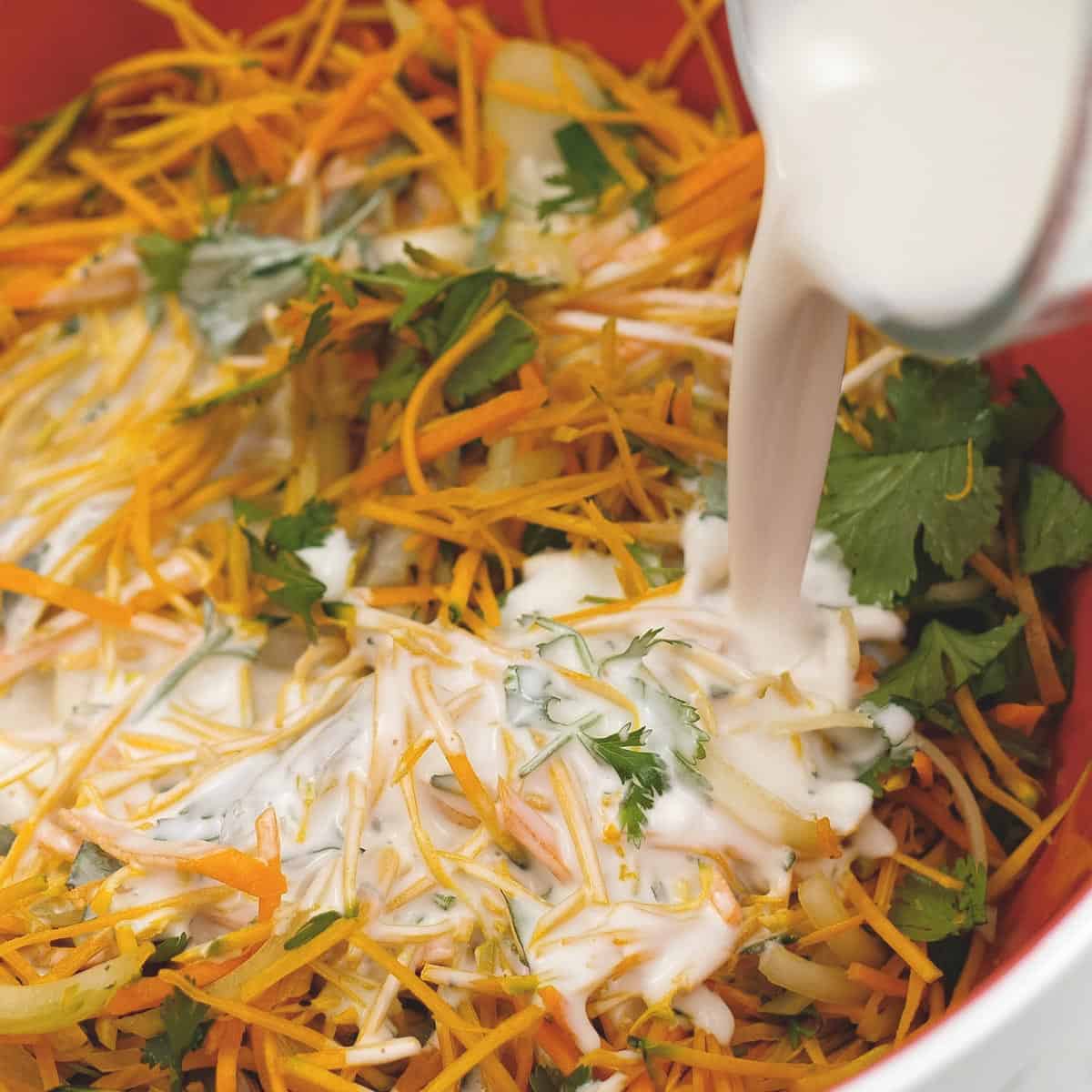 Batter being poured over the shrimp and vegetables.