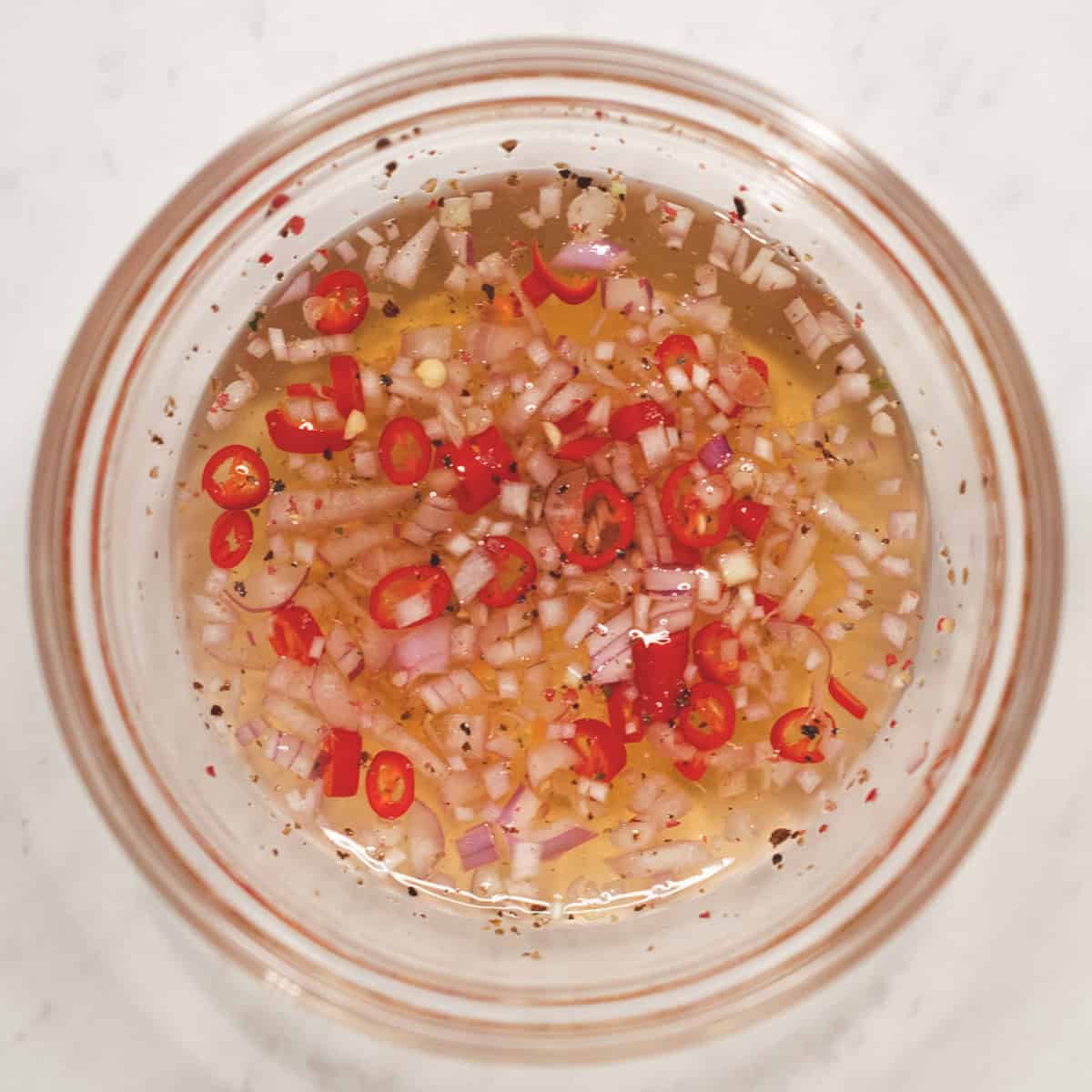 Spicy vinegar dipping sauce in a bowl.