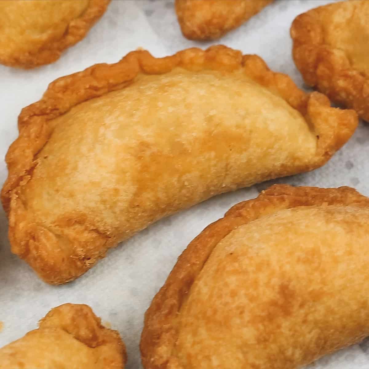 Fried empanadas on paper towels.