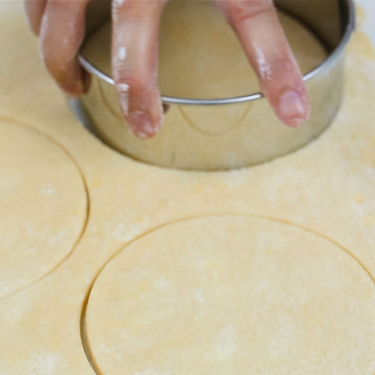 Cutting rounds on a rolled-out dough.