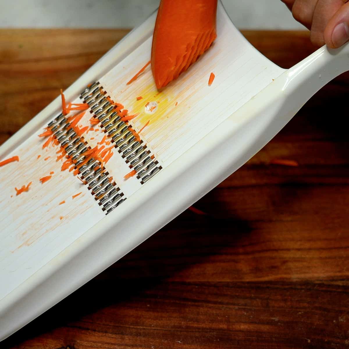 Shredding carrot using a julienne slicer
