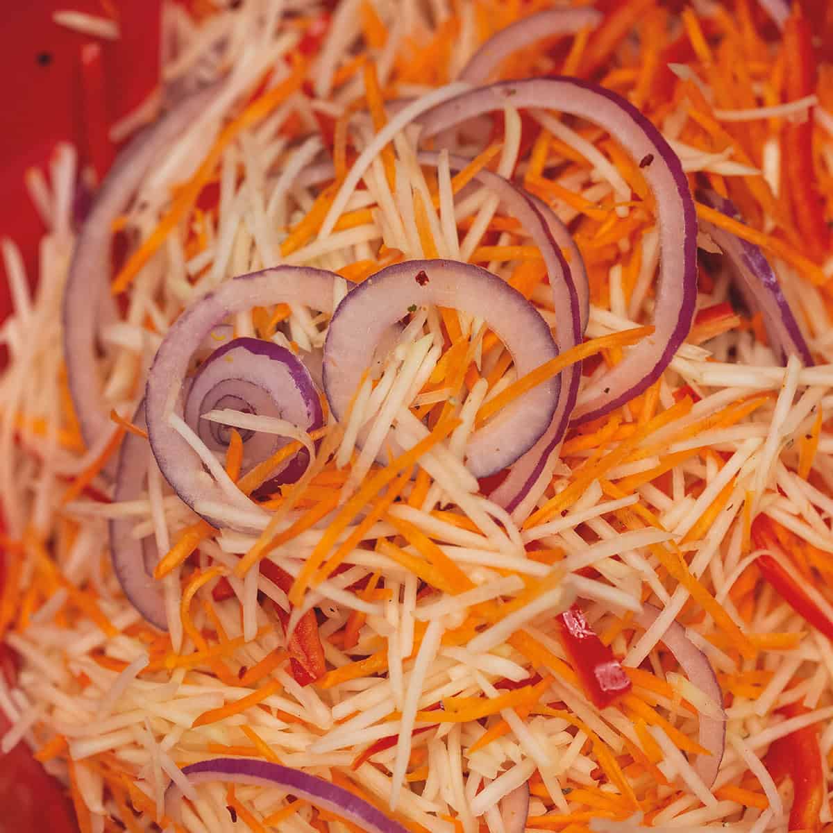 Slicing red onion thinly.