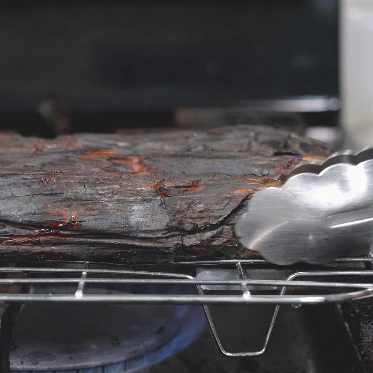 Fire-roasting the eggplant on the stovetop.
