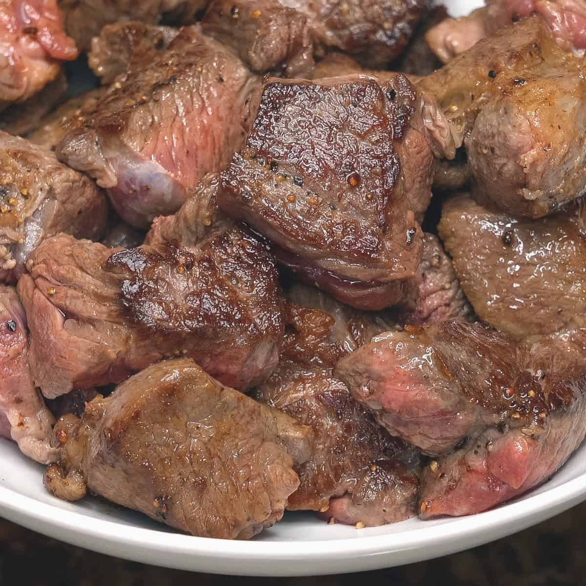 Seared chunks of beef in a bowl.