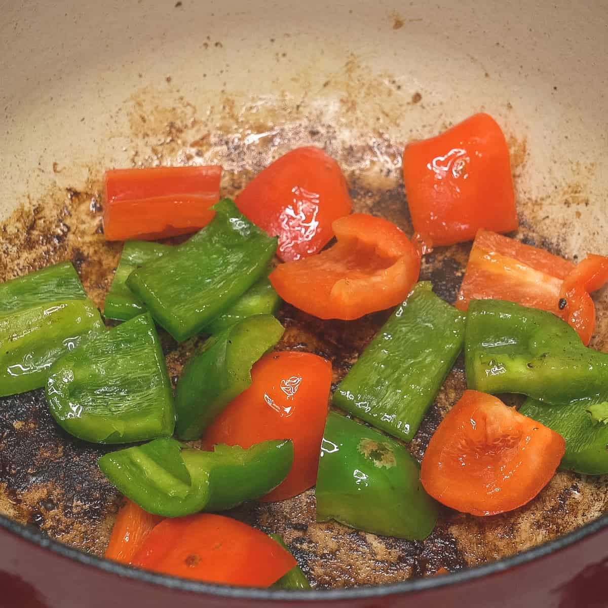 Searing the red and green bell peppers.