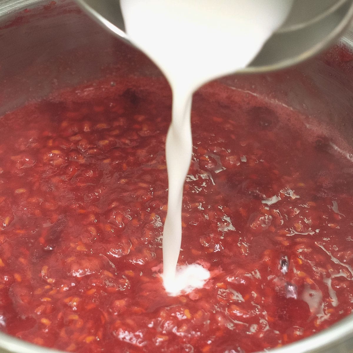 Adding slurry to the mashed raspberries.