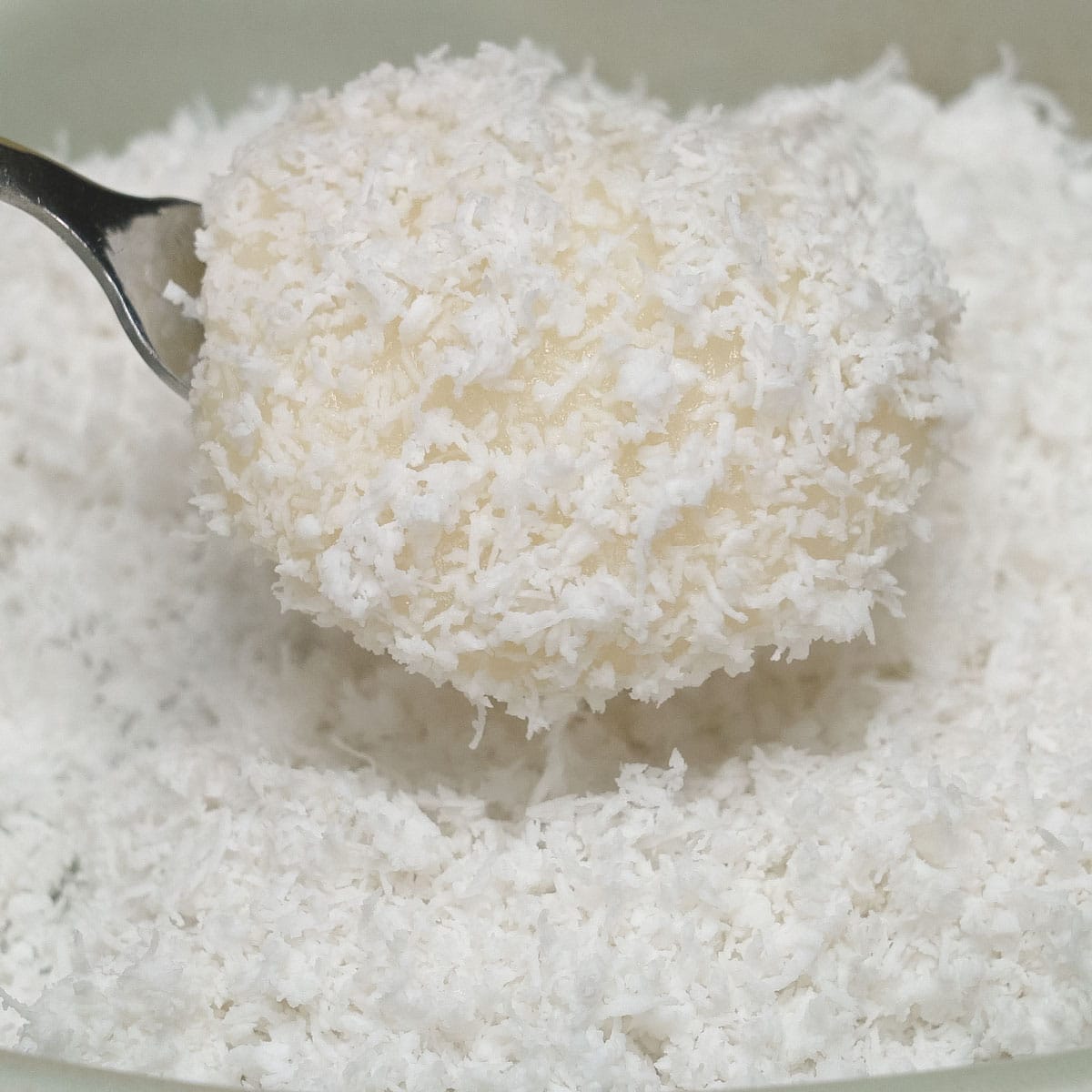 Coating Palitaw (Sweet Rice Cakes) with coconut