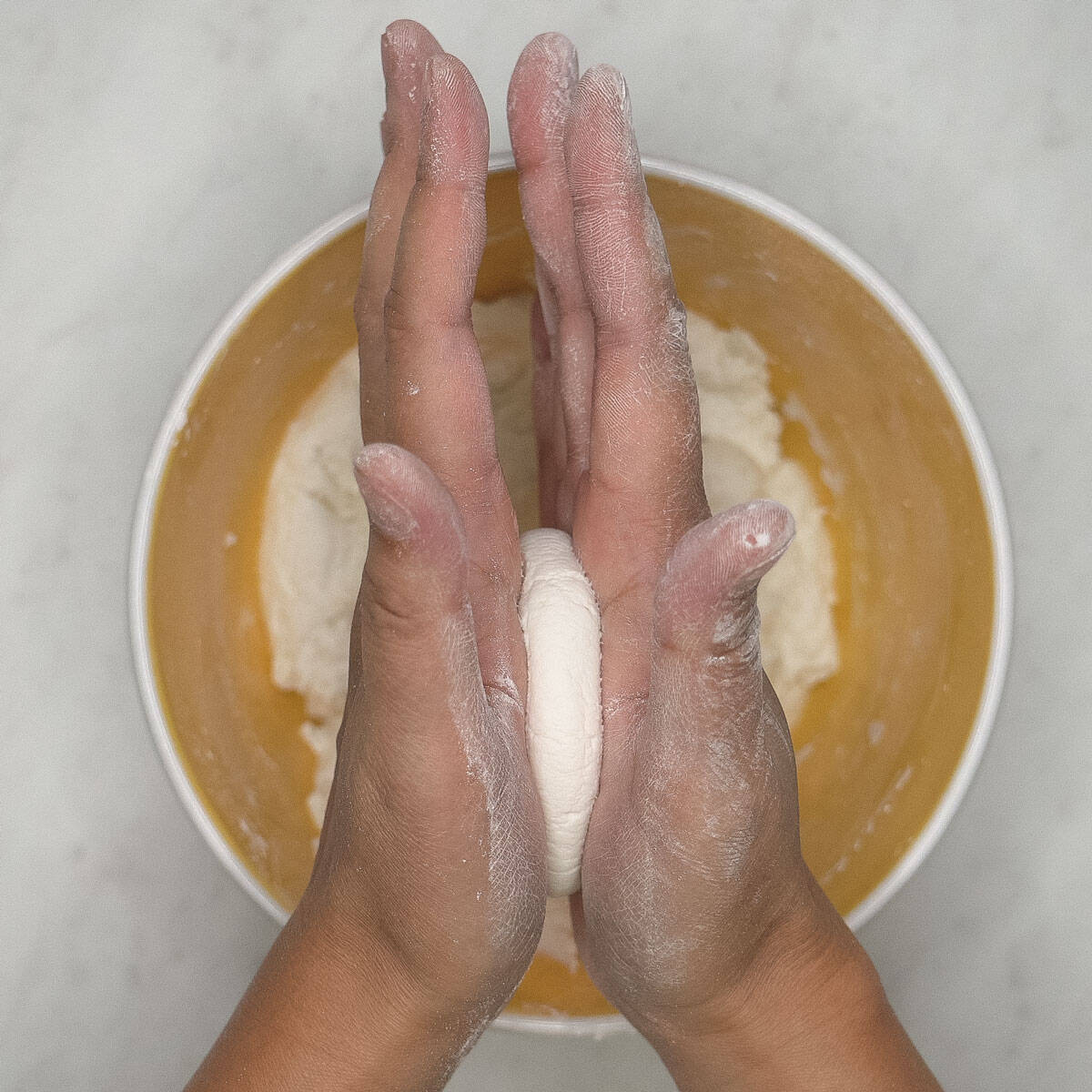 Pressing the dough between the palms