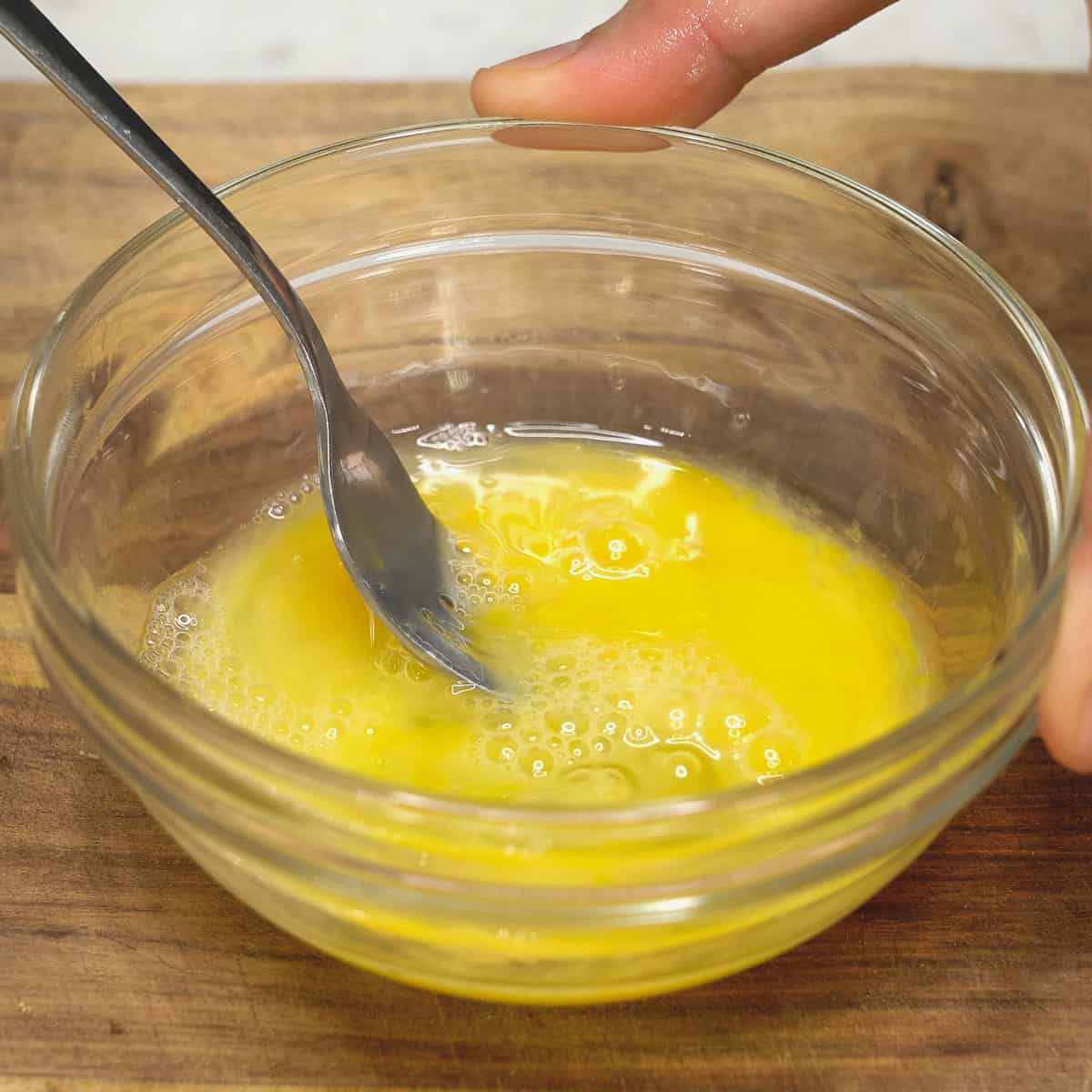Beating the egg in a bowl.