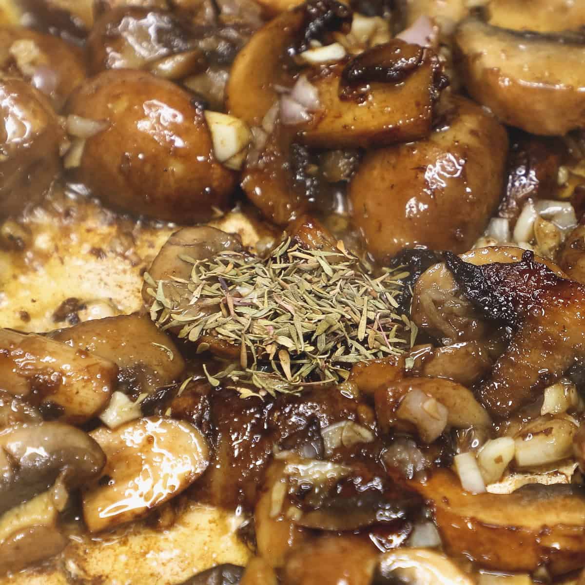 Added the dried thyme to the mushrooms in the pan.