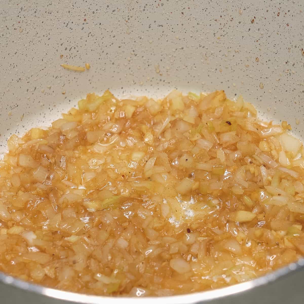 Sauteing garlic and onion in a pot.