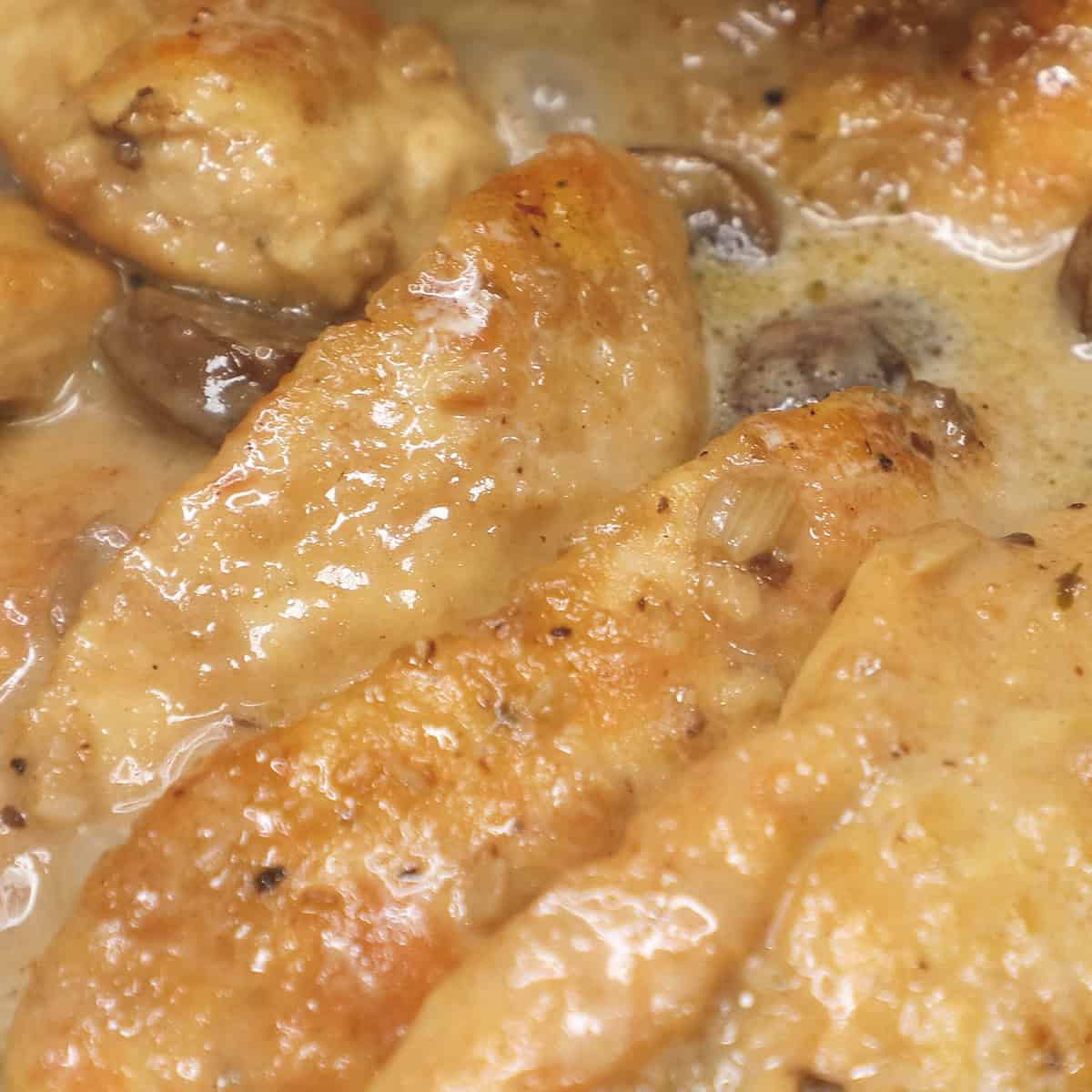 chicken cooking in marsala sauce.
