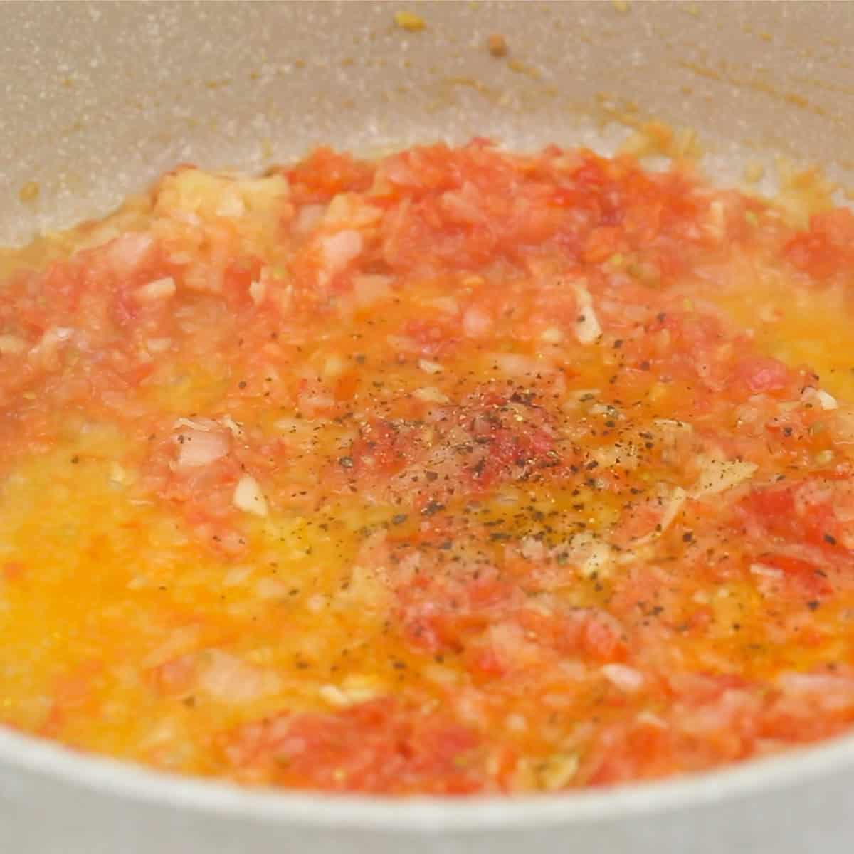 Sauteing the aromatics in the pan.