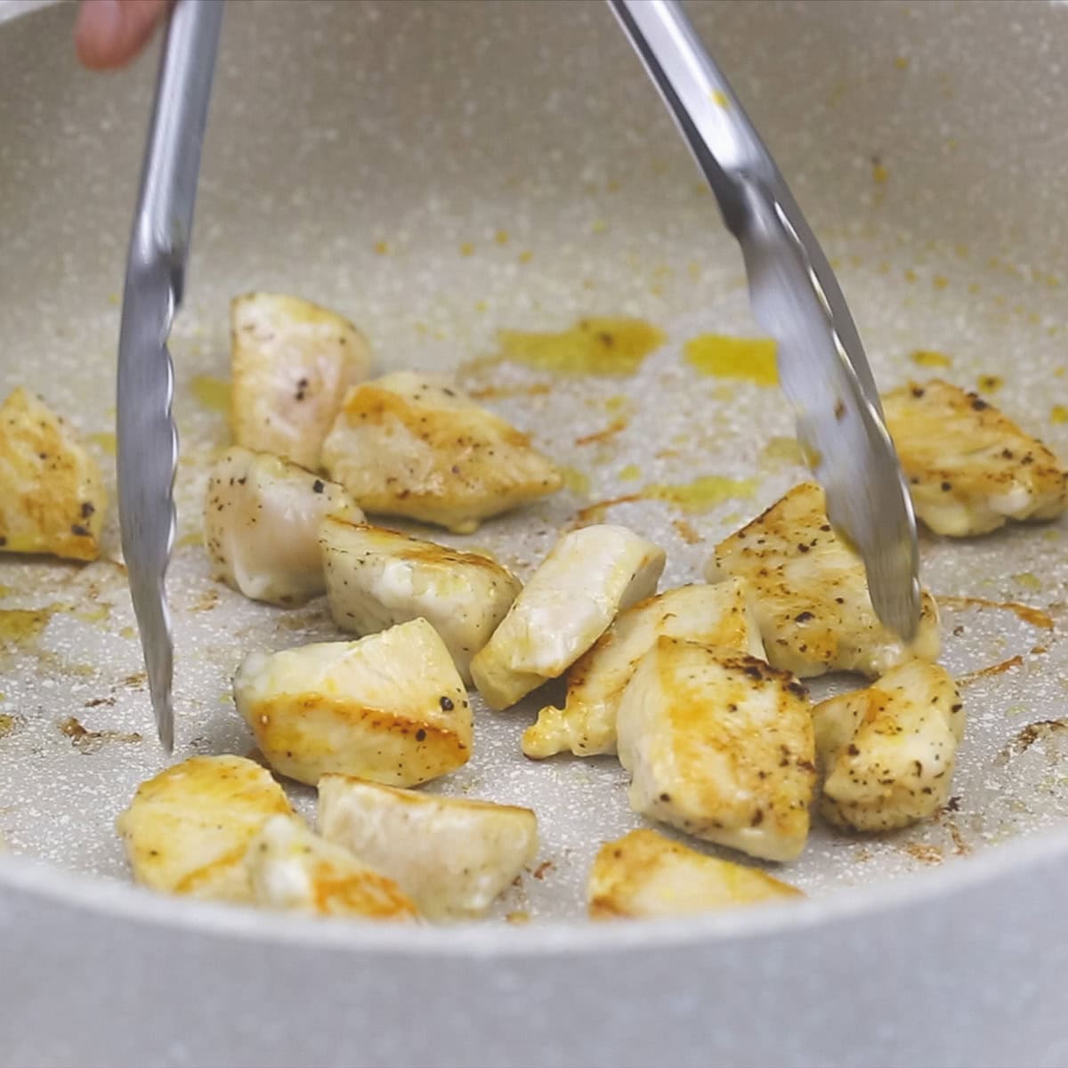 searing the chicken in the pan