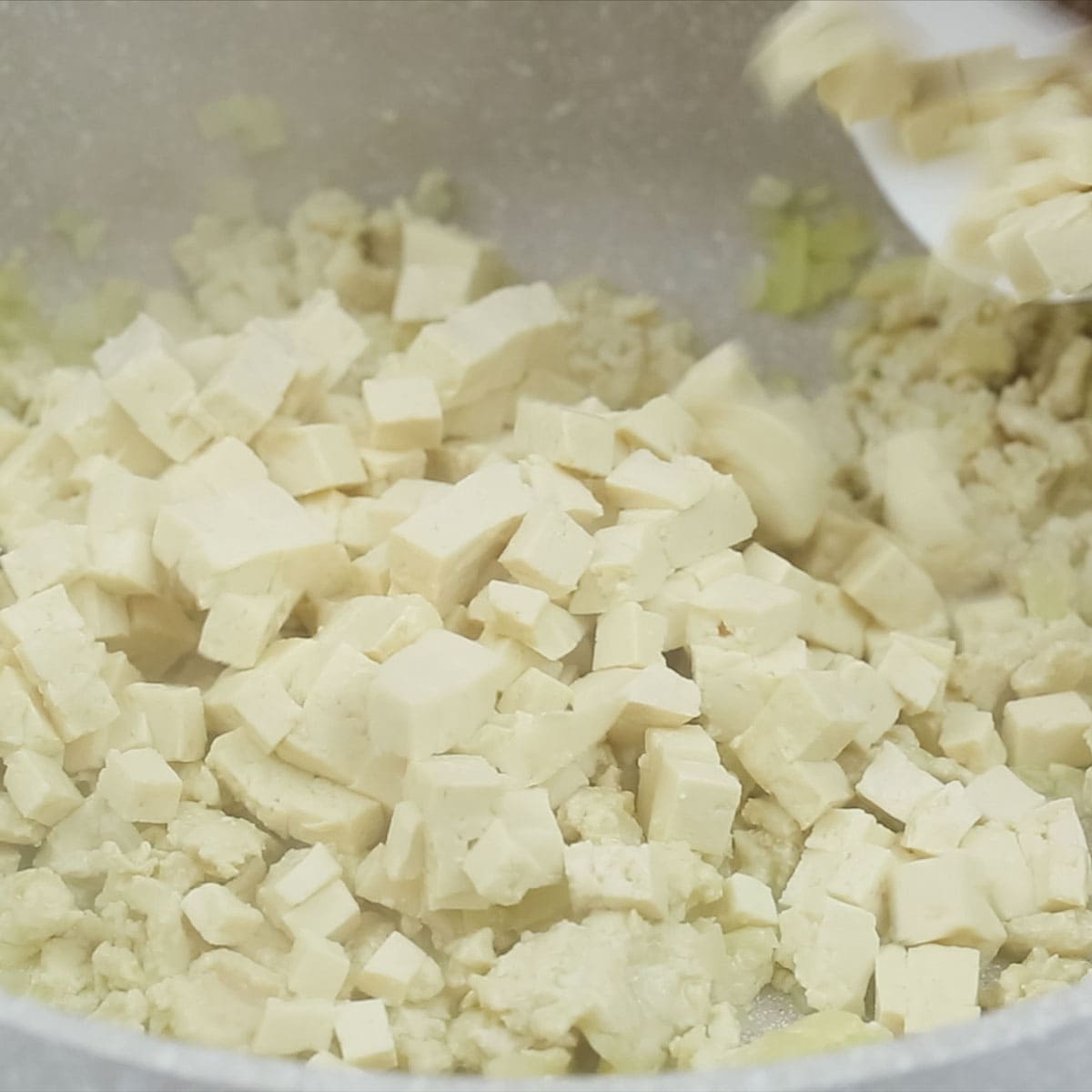 adding tofu in the pan