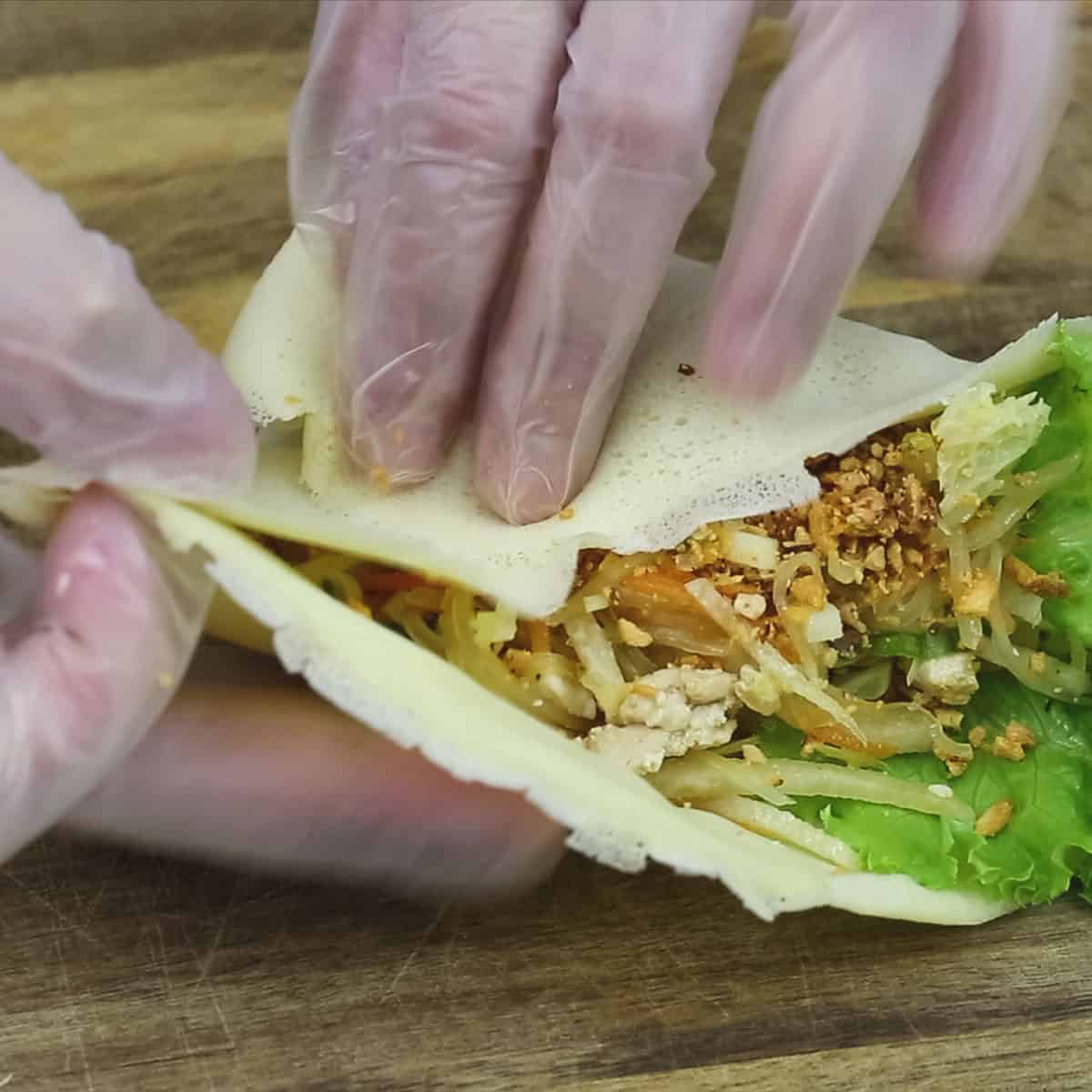 Folding the sides over the middle.
