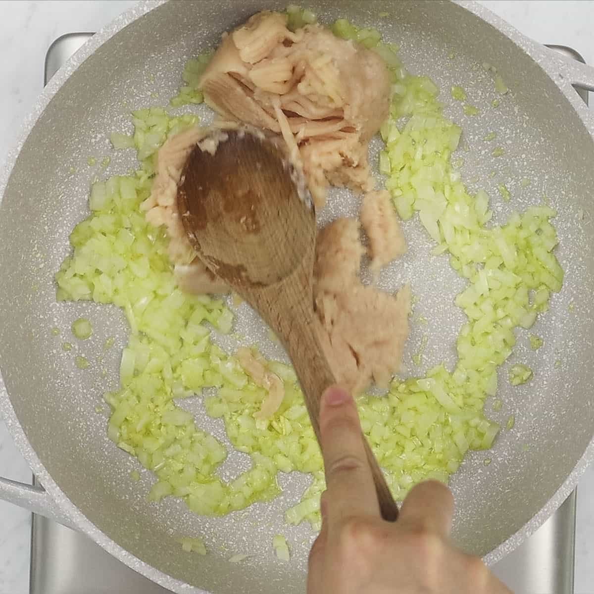 Breaking up the ground meat with the aromatics