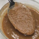Lechon sauce in a bowl scooped by a spoon.