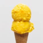 Mango Queso Ice Cream on a cone.