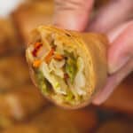 Holding a cut Lumpiang Gulay cross section.