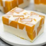 A slice of Mango Gelatin on a plate.