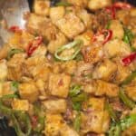 Tofu sisig in a casts iron skillet.