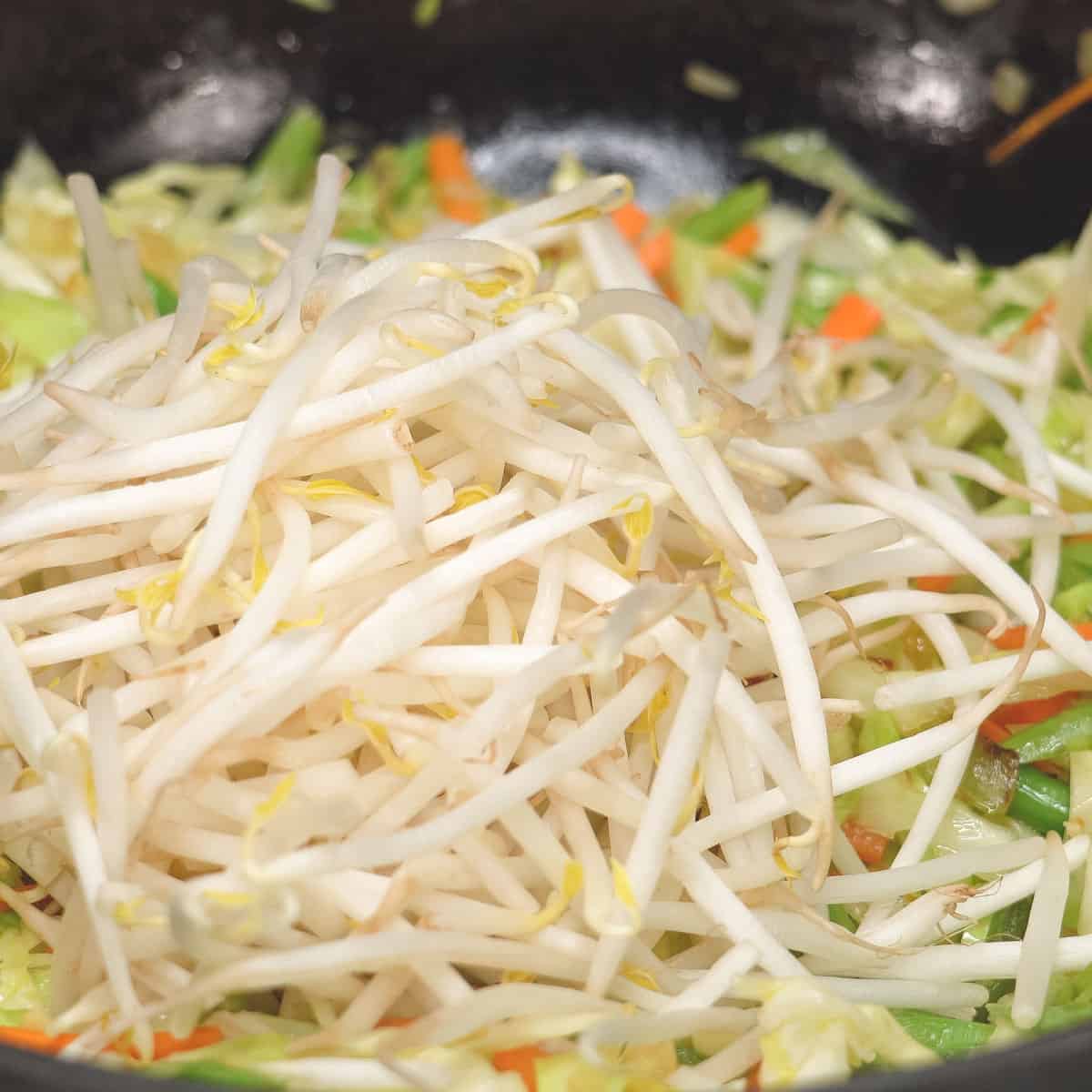 cooking mung bean sprouts in the wok.