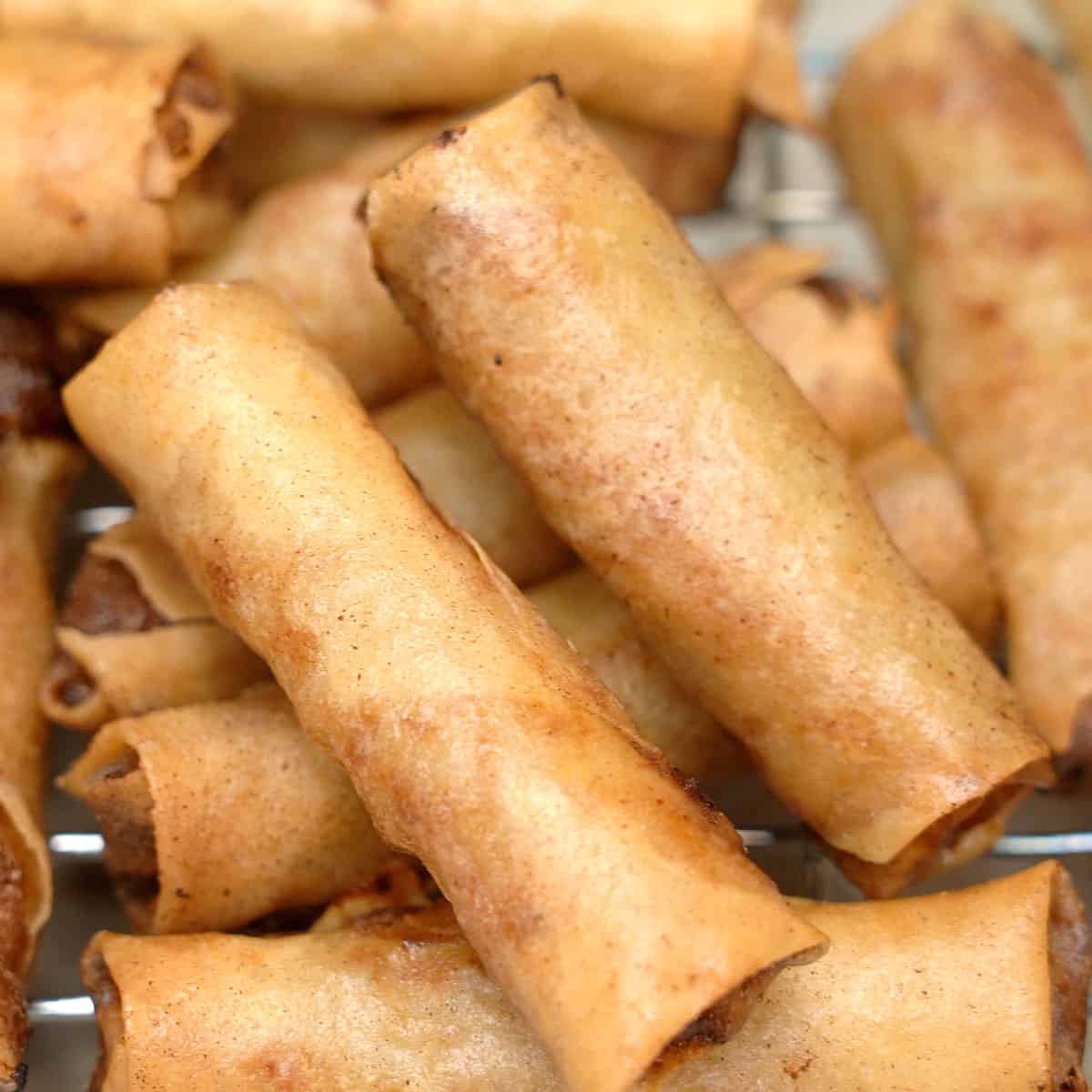 Draining the fried lumpia on a wire wrack.