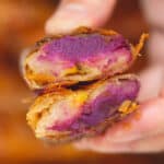 Holding Ube Turon cut in half cross section.