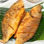 Crispy Fried Whole Fish on a plate with banana leaf.