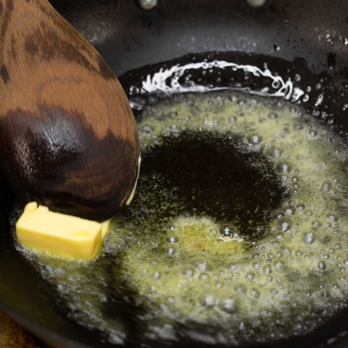 Melting the butter in the wok.