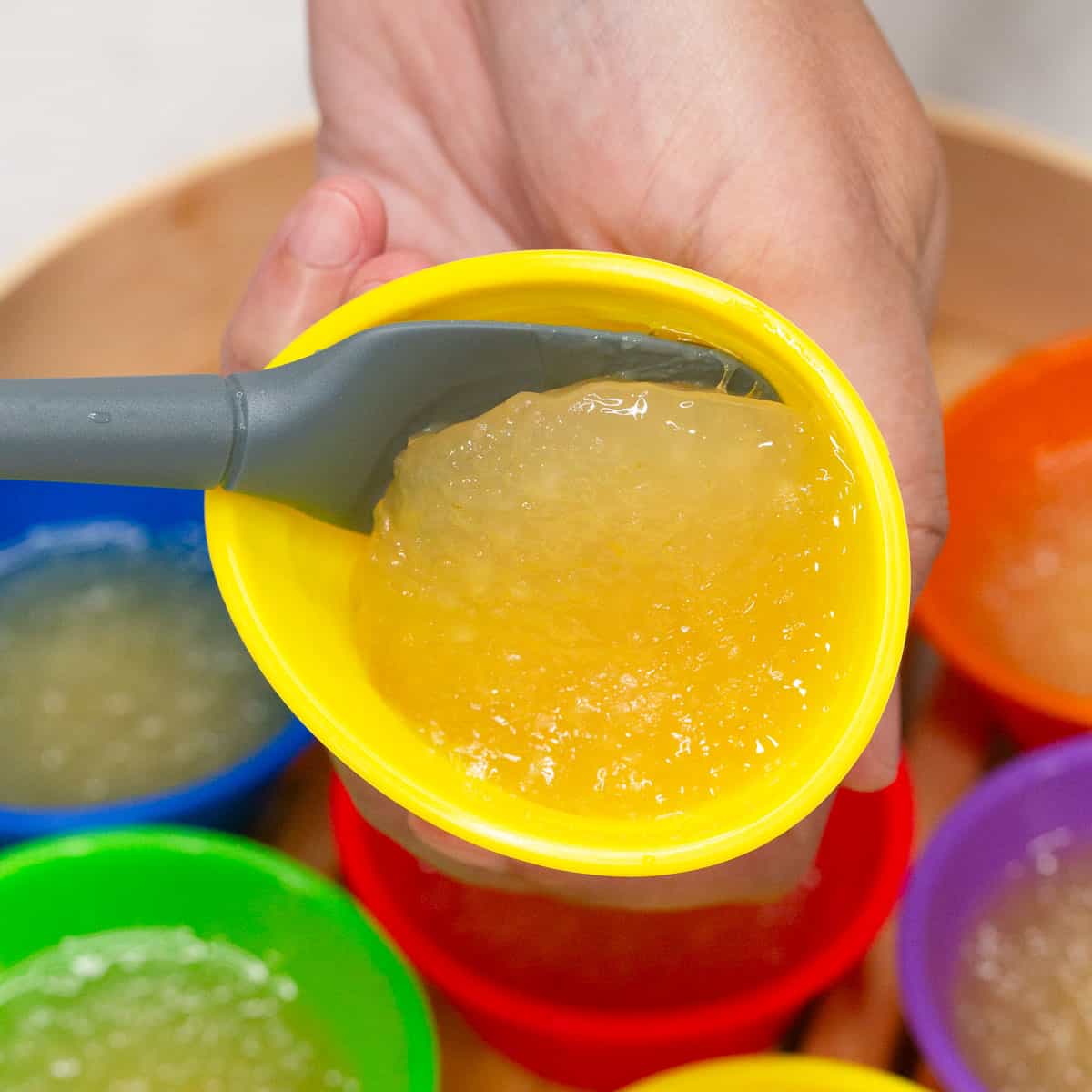 Scooping the cooked Pichi-Pichi from the mold using a spatula.