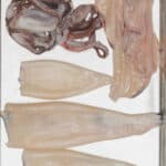 Cleaned squid on a baking sheet.