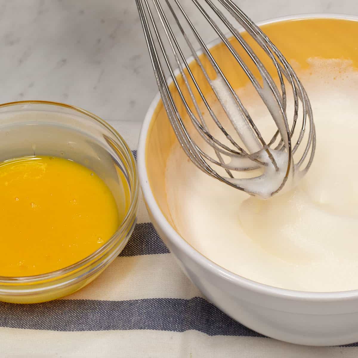 Whisking the egg whites until frothy.