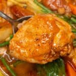 Chicken Pochero scooped by a spoon.