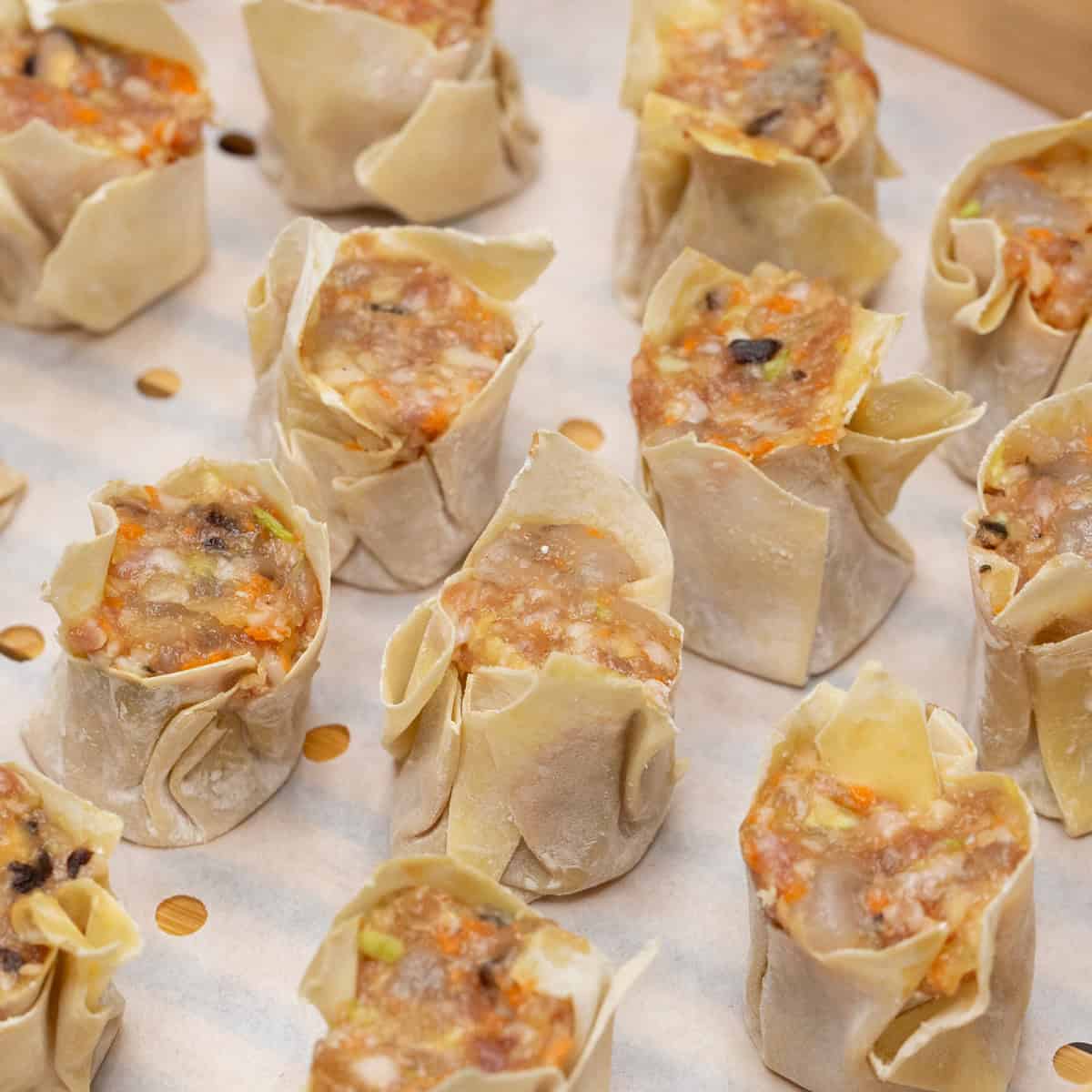 Siomai in the steamer basket evenly spaced apart.