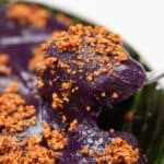 Ube kalamay picked by a fork.