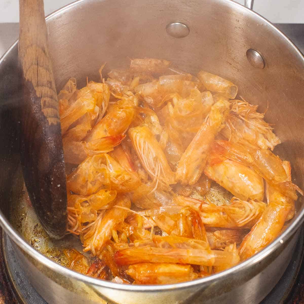 Sauteing the shrimp heads and tails