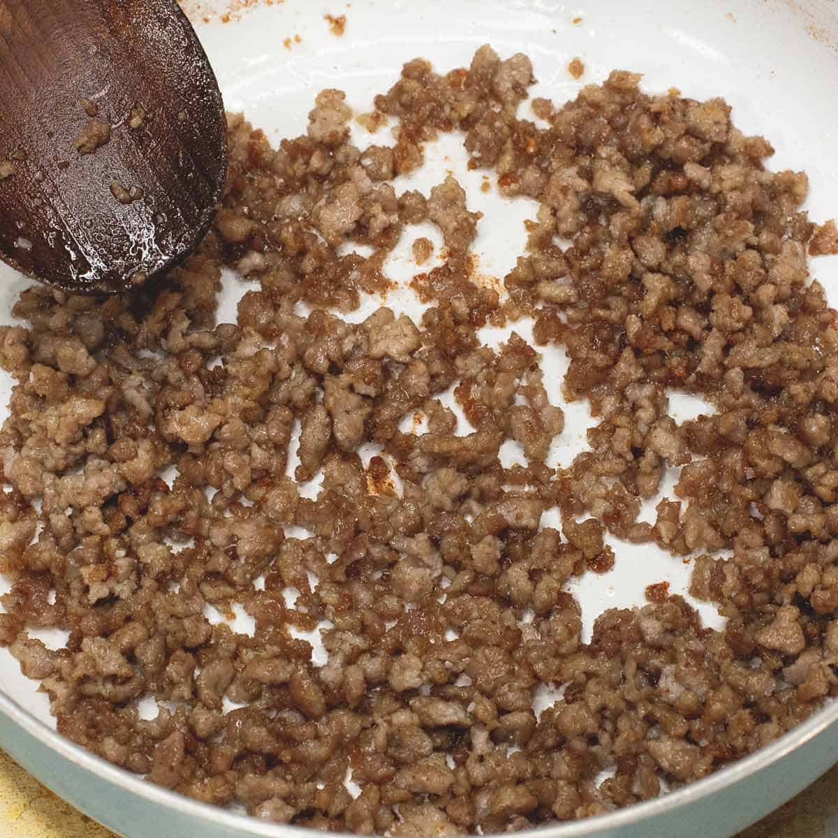 Browning the ground pork in the pan.