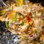 Bangus sisig recipe scooped by a spoon.