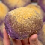 Holding ube cheese pandesal.