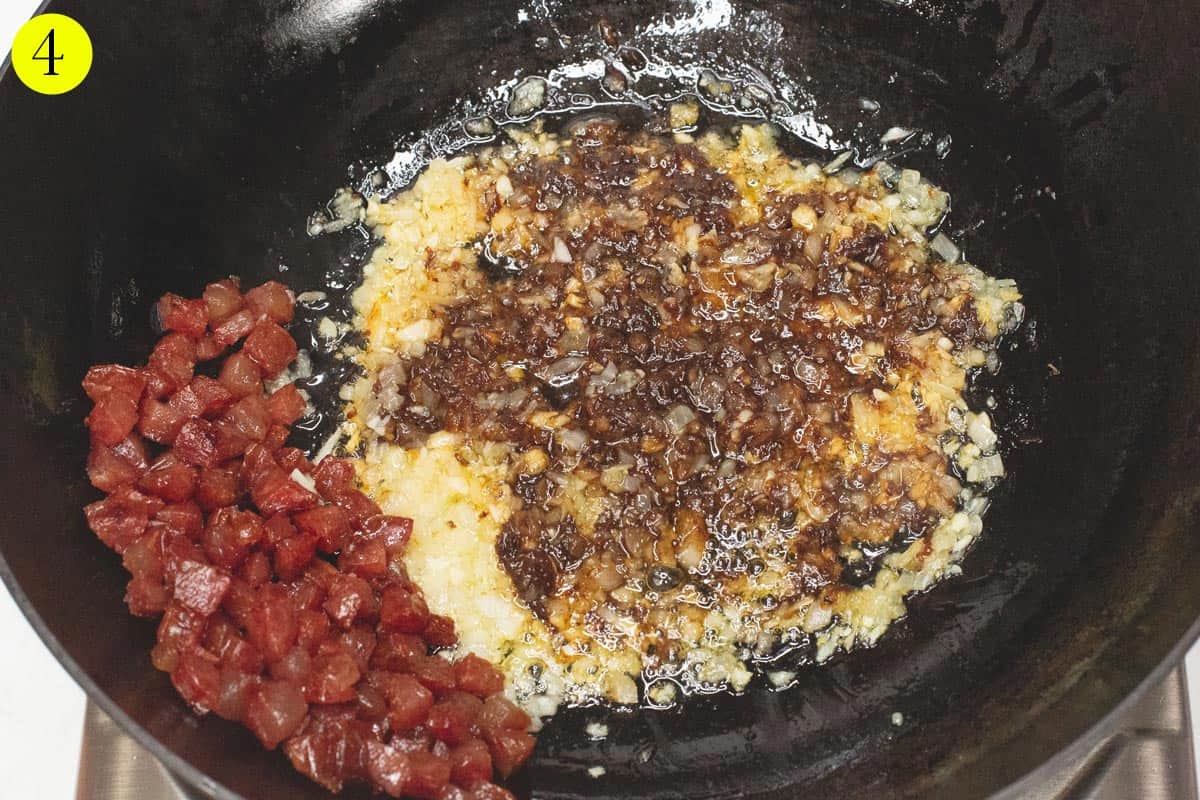 Sauteing the shrimp paste with the aromatics in the wok.