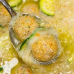 Cooked almondigas scooped by a spoon.