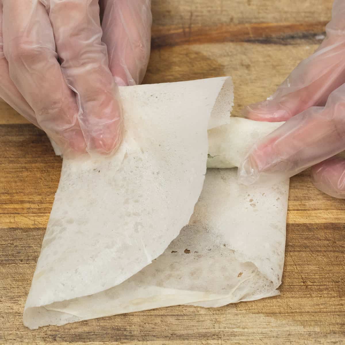 fold the open side of the wrapper over the pepper.