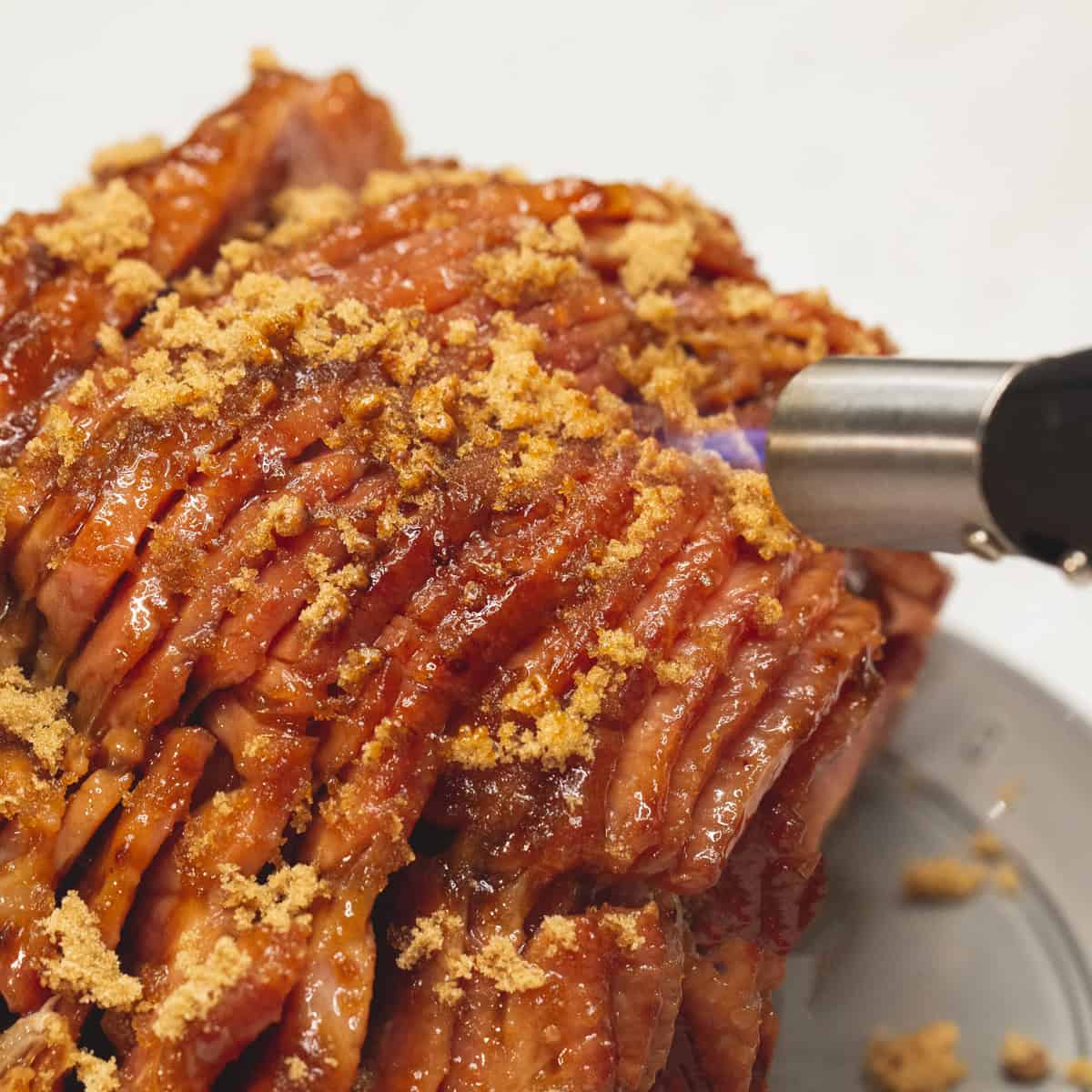 Adding brown sugar to the surface of the ham, then caramelizing it with a blowtorch.