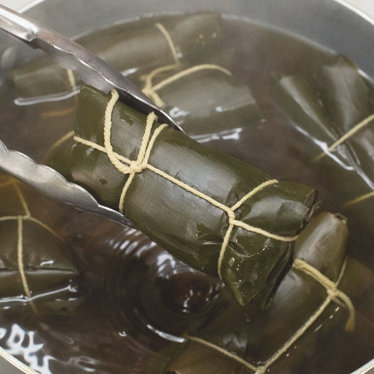 Boiling the suman submerged in water.