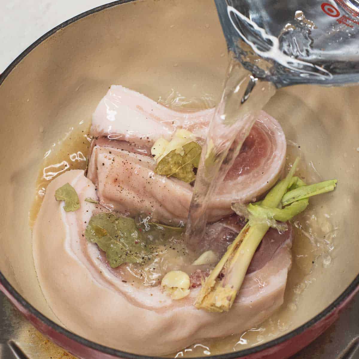 Boiling the pork belly in the pot.